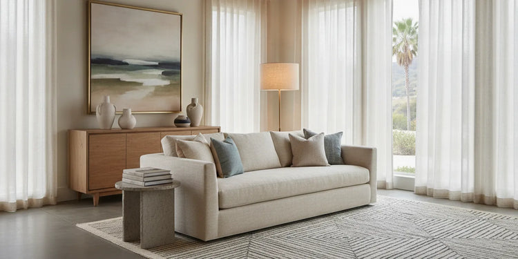 Contemporary living room vignette in a Southern California furniture showroom with a sofa, natural textures, and soft daylight