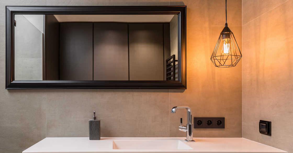 Pendant light hung over a bathroom sink