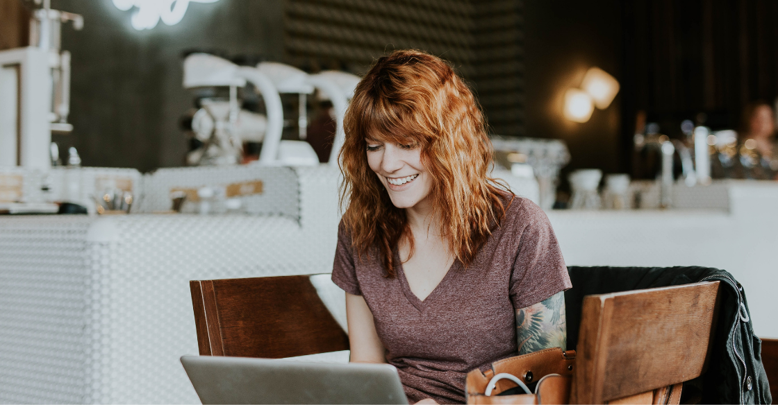 Woman working on her laptop in a hotel