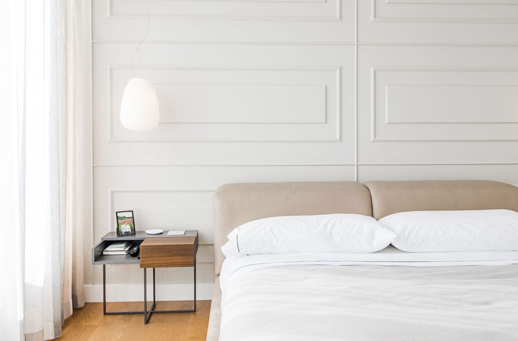 A minimalist interior design featuring a cream textured wall